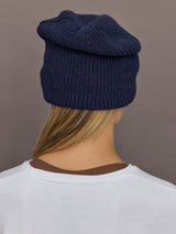 Back view of indigo blue cotton-cashmere beanie showing slouch fit.