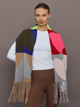 Model wearing oversized multi-color knit scarf with heart pattern, front view.