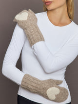 Model wearing camel wool mittens with heart patches, front view with crossed arms.