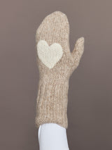 Close-up of camel knit mitten with cream heart patch, front view.