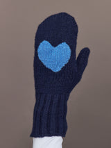 Close-up of indigo blue knit mitten with light blue heart patch, front view.