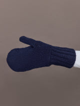 Side view of indigo blue knit mitten showing ribbed cuff detail.