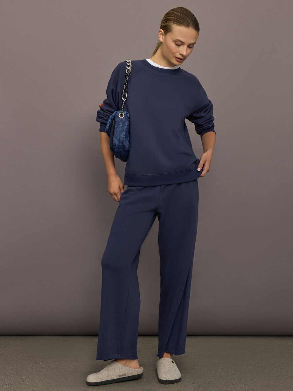 Full outfit with indigo blue heart patch sweatshirt and matching pants, front full-body view.