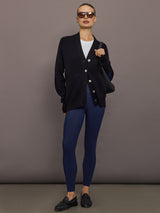 Full-body view of model wearing black cardigan with navy leggings.
