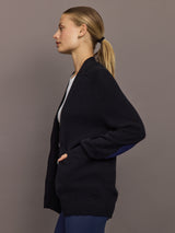 Side view of black cardigan showing heart patch on sleeve.