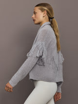 Side view of platinum cardigan highlighting fringe mid-sleeves and cashmere texture.