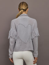 Back view of platinum cardigan showing embroidered heart motif and fringe sleeves.