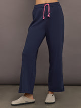 Women’s indigo blue sweatpants with pink drawcord, front view.