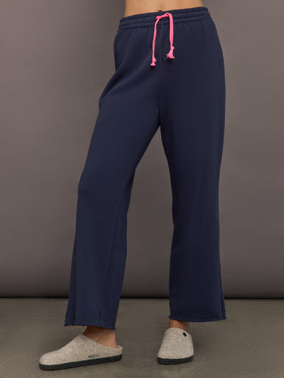 Women’s indigo blue sweatpants with pink drawcord, front view.