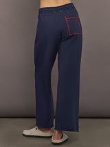 Back view of indigo blue sweatpants highlighting contrast pocket detail.