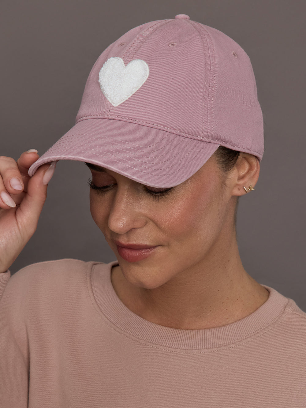 Model is wearing KR Imperfect Chenille Heart Hat in mauve, front view.