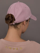 Model is wearing KR Imperfect Chenille Heart Hat in mauve, back view with adjustable strap.