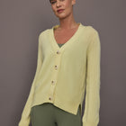 Model is wearing Featherweight Cashmere Button Cardigan in Lemon Tint, front view.