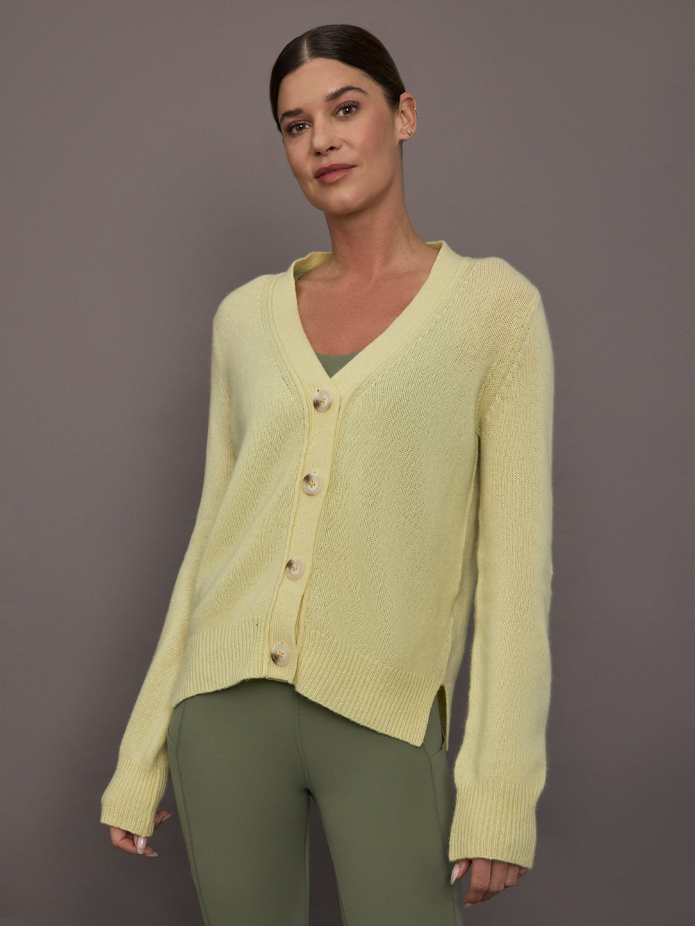 Model is wearing Featherweight Cashmere Button Cardigan in Lemon Tint, front view.