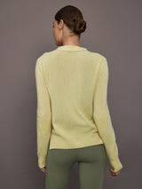 Model is wearing Featherweight Cashmere Button Cardigan in Lemon Tint, back view.
