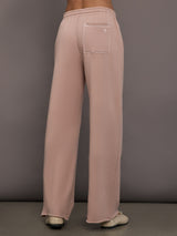 Model is wearing Weekend Barb fleece sweatpant in Mauve, back view.