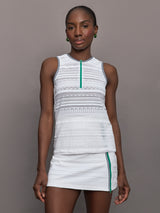 Model wears a semi-fitted white sleeveless tank with green zipper and trim.