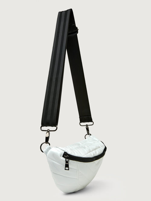 White patent leather bag with black hardware, featuring a half moon shape.