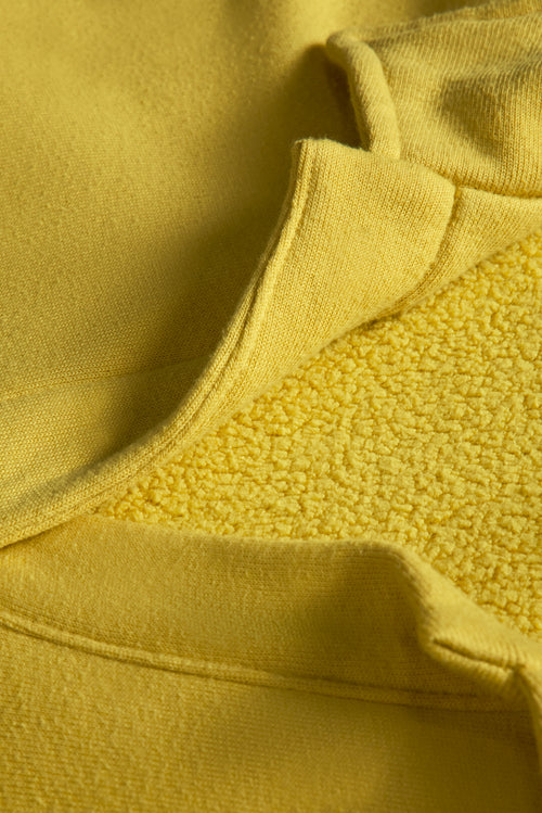 Close up of the Johnny Collar Sweatshirt in Mango Mint highlighting soft fleece interior texture.
