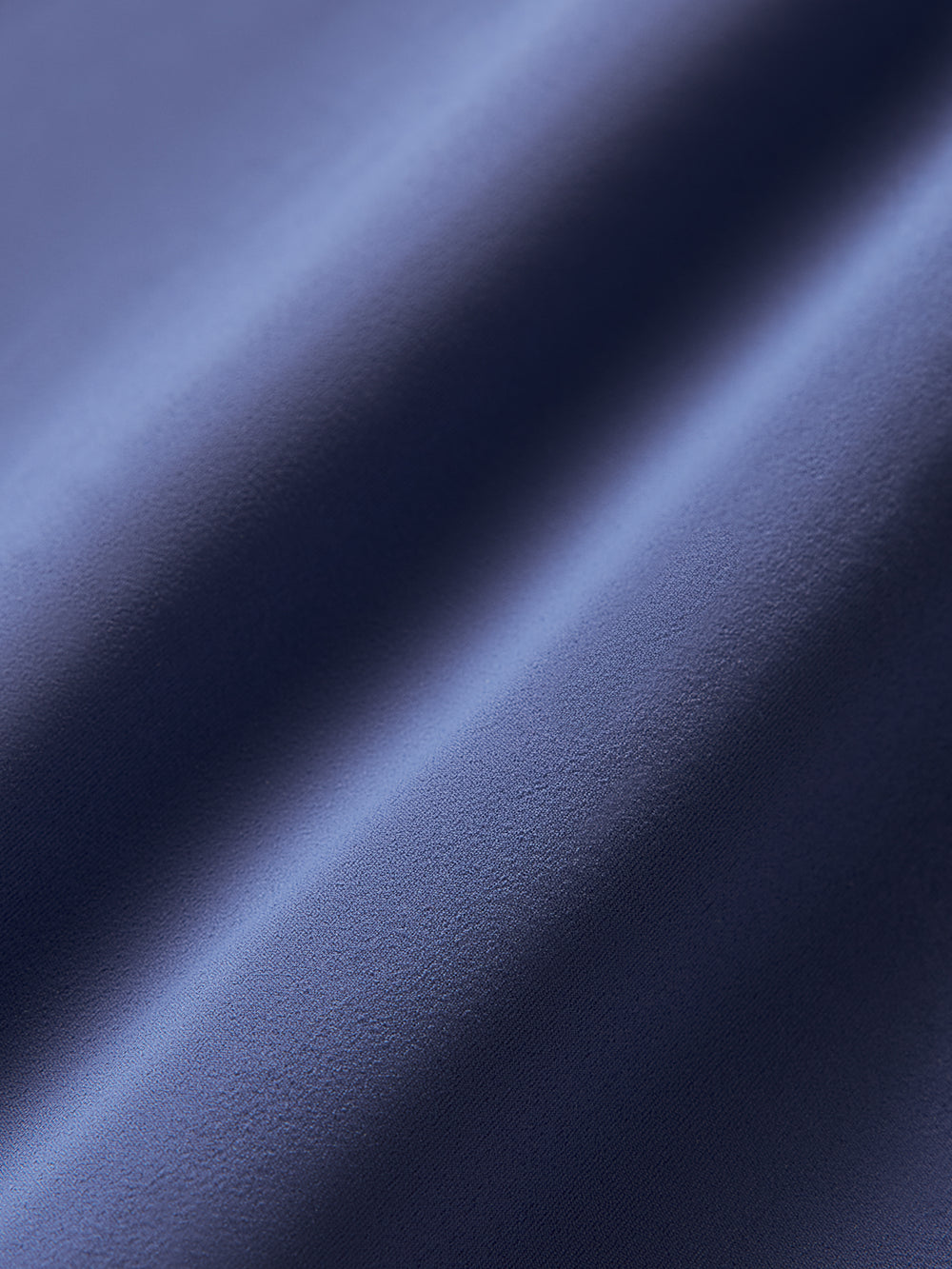 Close-up of dark blue fabric with a smooth texture