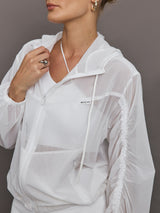 Model wears white Indy Jacket with a relaxed fit and full zip front, with elastic cuffs and a sheer, lightweight fabric for a translucent look.
