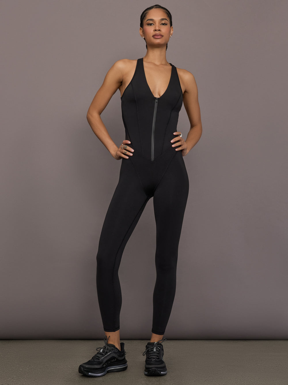 Model is wearing the Odyssey Jumpsuit in black, front full body view.