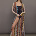 Model wears long cover-up with chevron pattern and subtle shimmer details, offering full coverage and a tie front.