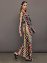 Model wears long cover-up with chevron pattern and subtle shimmer details, offering full coverage and a tie front.