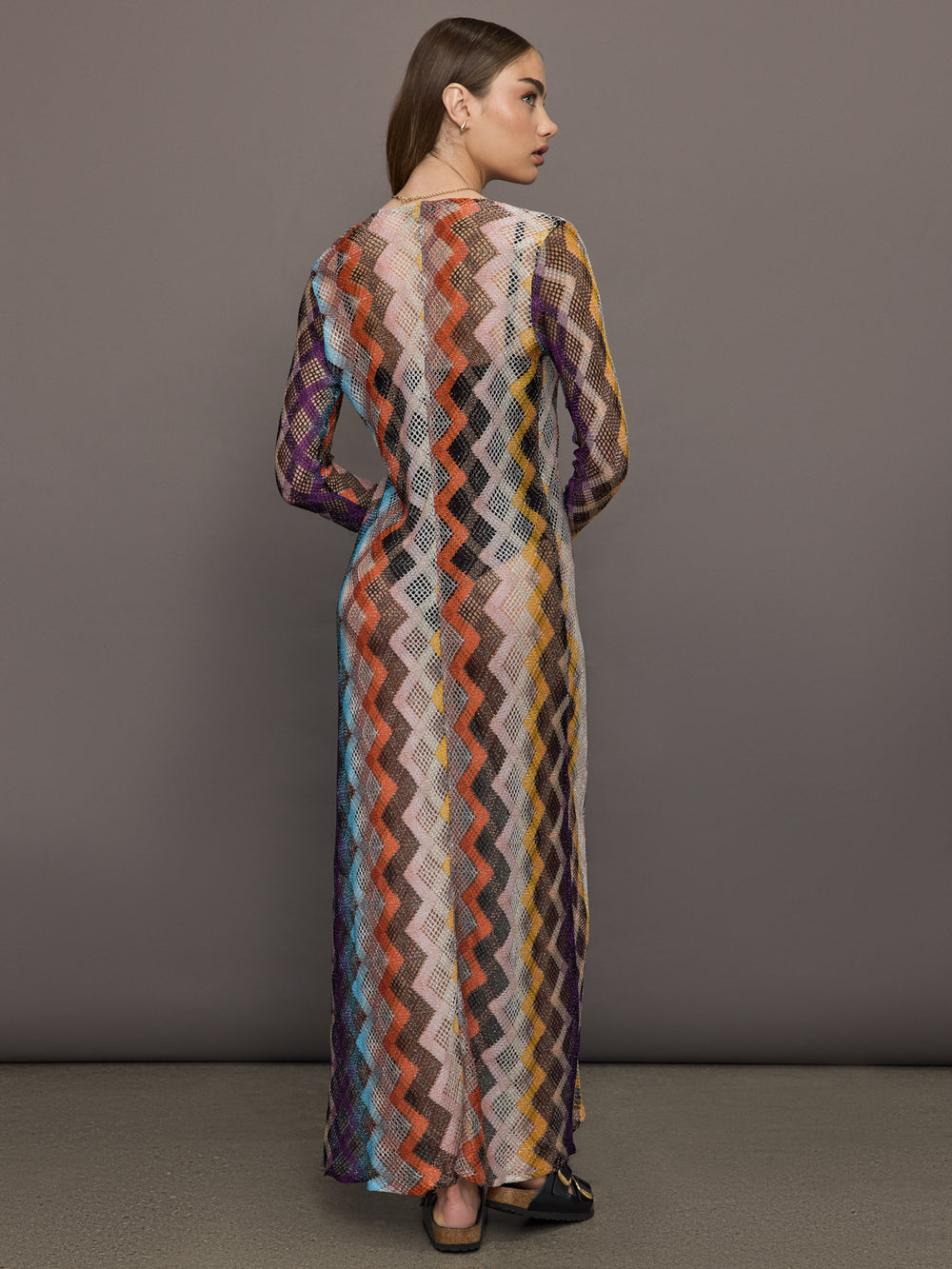 Model wears long cover-up with chevron pattern and subtle shimmer details, offering full coverage and a tie front.