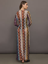Model wears long cover-up with chevron pattern and subtle shimmer details, offering full coverage and a tie front.