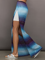 Model wears the Long skirt in multi-blue with a high slit and semi-sheer fabric, with a lightweight, more fit silhouette.