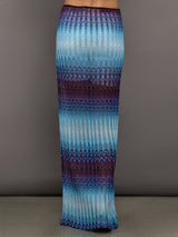 Model wears the Long skirt in multi-blue with a high slit and semi-sheer fabric, with a lightweight, more fit silhouette.