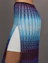 Model wears the Long skirt in multi-blue with a high slit and semi-sheer fabric, with a lightweight, more fit silhouette.
