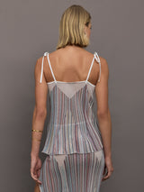 Model wearing a multicolor tank top with a loose fit and adjustable tie straps.