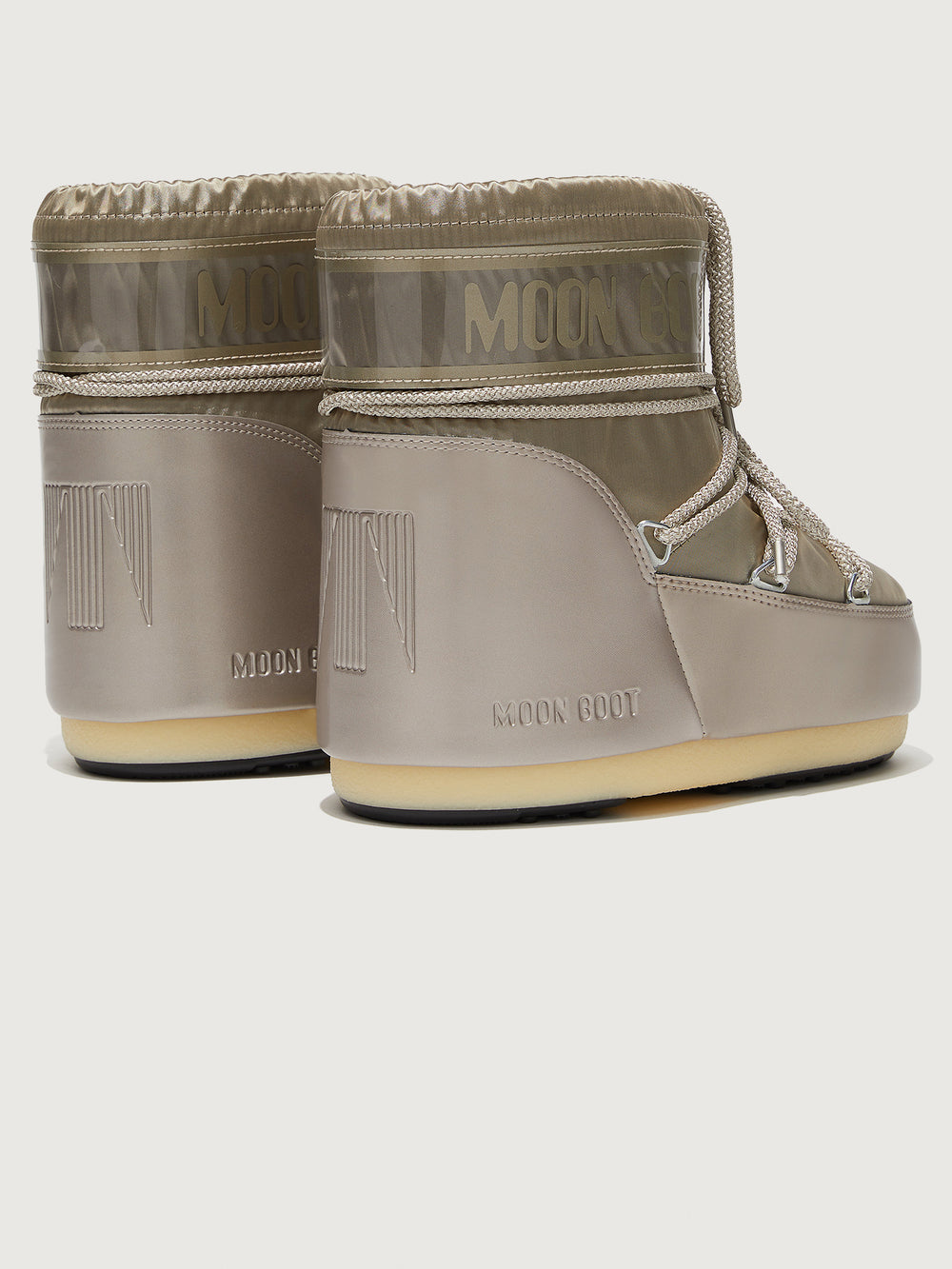 A pair of Moon Boots in gray with drawstrings.