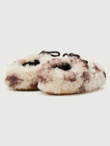 Pair of fluffy slippers with a white background