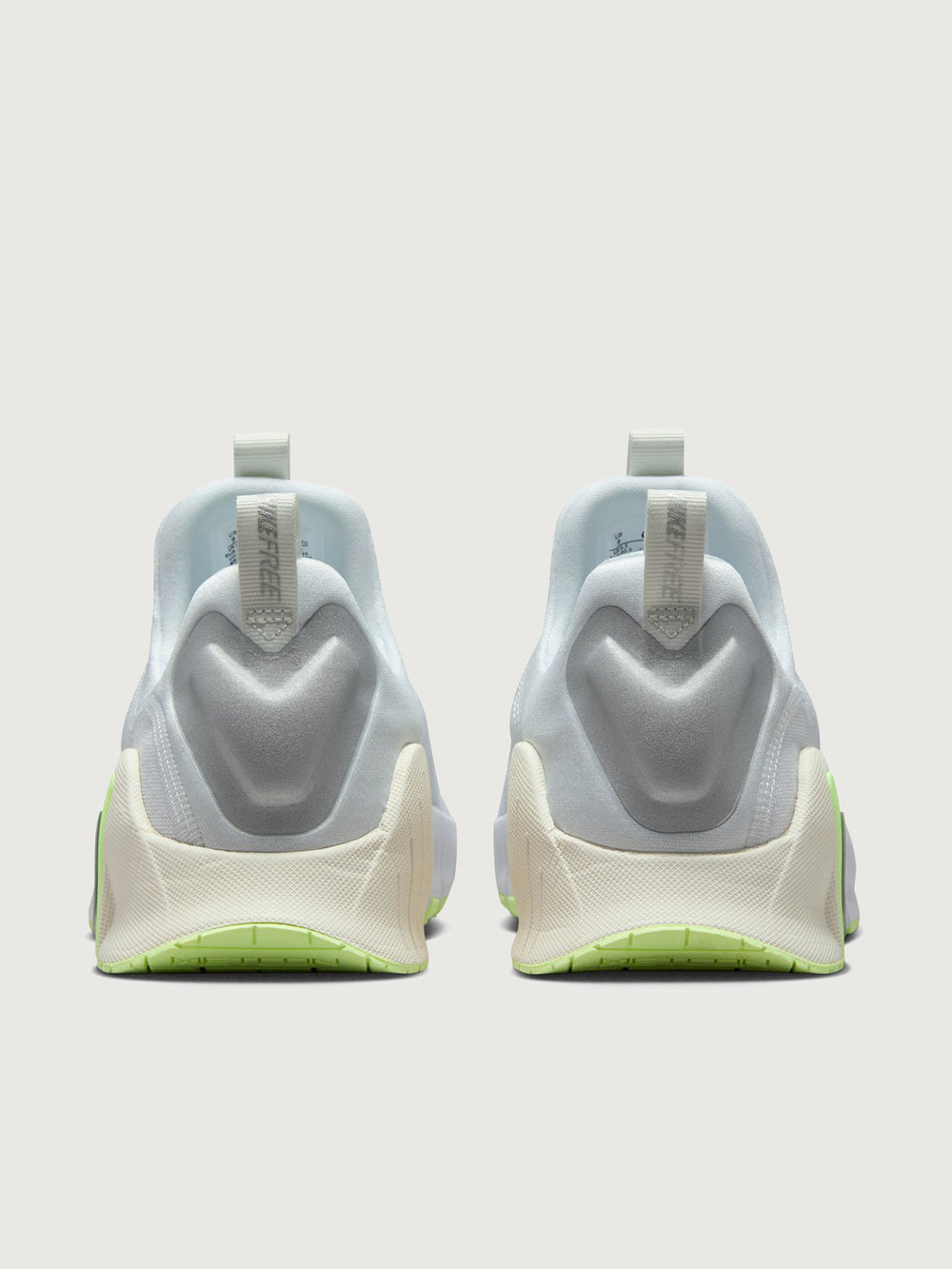 White athletic shoe with neon green sole.