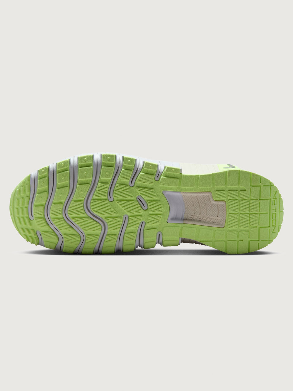 White athletic shoe with neon green sole.
