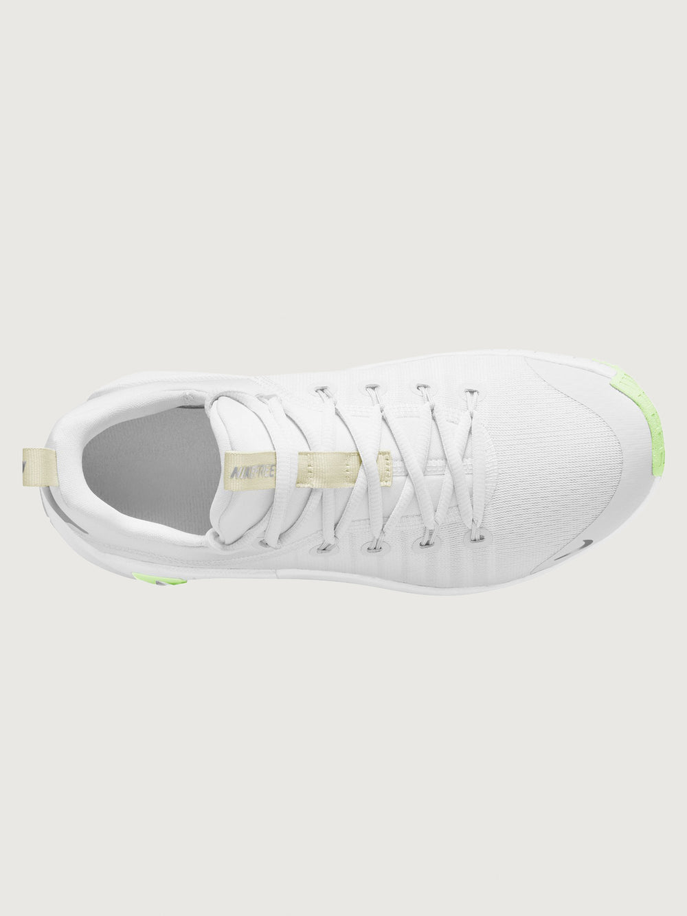 White athletic shoe with neon green sole.