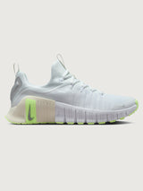 White athletic shoe with neon green sole.