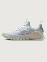 White athletic shoe with neon green sole.