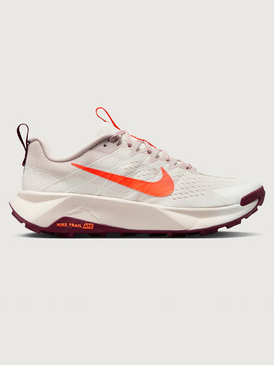 White running shoe with orange swoosh logo on a light gray background