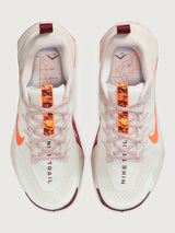 White running shoe with orange swoosh logo on a light gray background