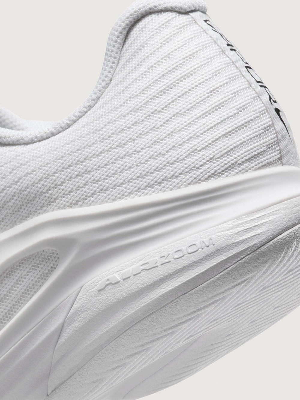 White athletic shoe with black swoosh logo on a white background