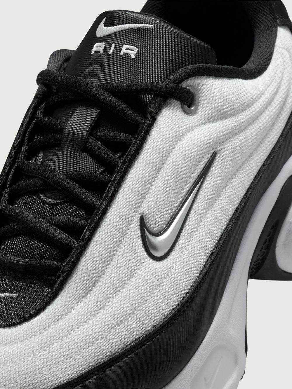 Black and white sneaker on a light gray background