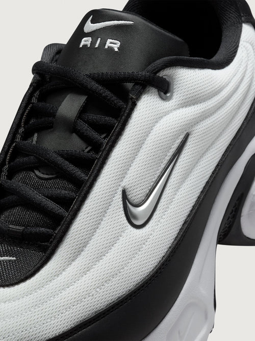 Black and white sneaker on a light gray background