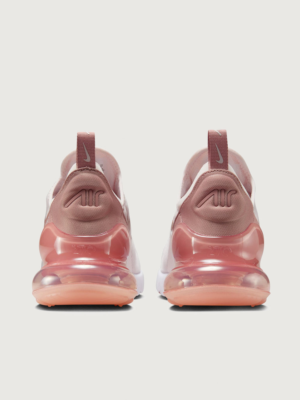 Pink and white sneaker with Nike logo.