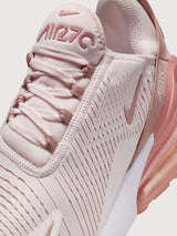 Pink and white sneaker with Nike logo.