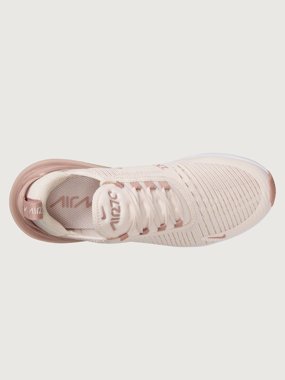Pink and white sneaker with Nike logo.