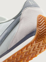 Nike Pacific sneaker in Sail and Metallic Silver, heel and gum sole detail.